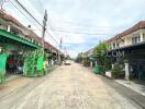 Street view of a residential neighborhood with houses along both sides