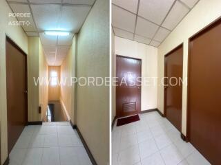 Interior view of a corridor with multiple doors and a stairwell