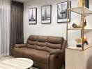 Modern living room with comfortable brown sofa, wall art, and open shelving