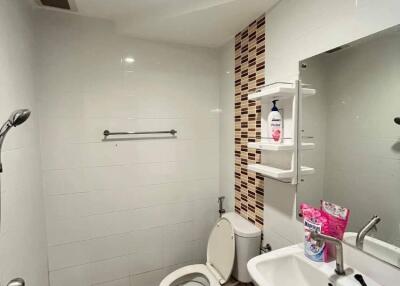 Modern bathroom with white tiles and features