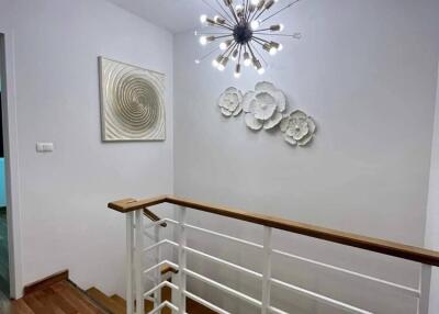 Well-lit staircase with modern lighting and artwork