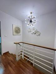 Well-lit staircase with modern lighting and artwork