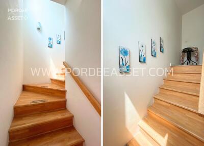 Bright staircase with wooden steps and wall decorations