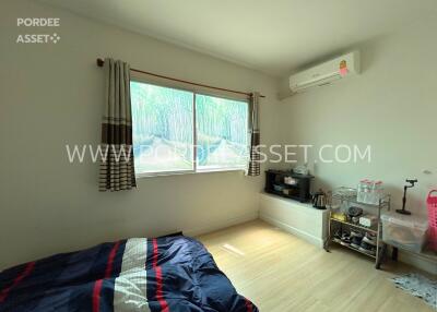 Bedroom with large window and air conditioning