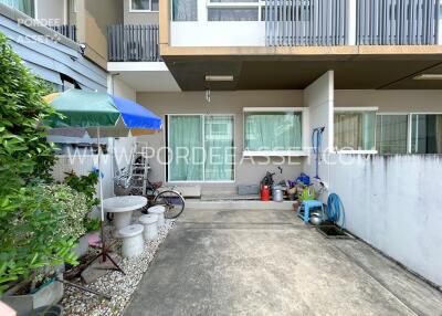 Outdoor view of the property with seating area and storage space