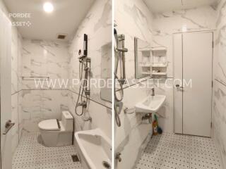 Modern bathroom with white marble tiles and sanitary fixtures