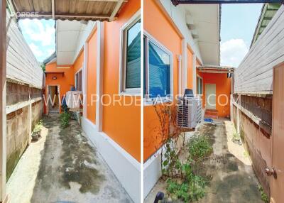 Side yard with orange exterior wall and air-conditioning unit