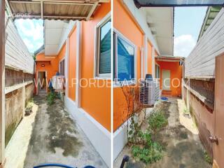 Side yard with orange exterior wall and air-conditioning unit