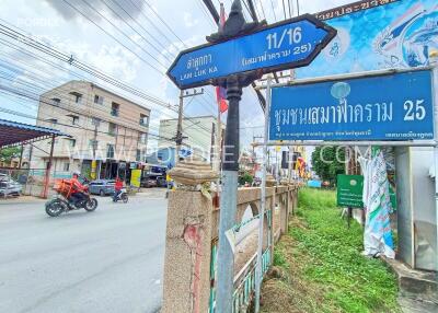 Street view with directional sign and surrounding buildings