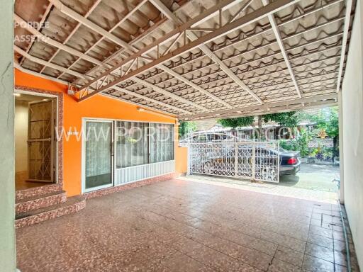 Carport area with tiled floor and metal roofing