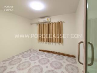 Empty bedroom with air conditioner and curtain