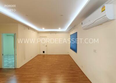 Spacious living room with wooden flooring, recessed lighting, and air conditioning