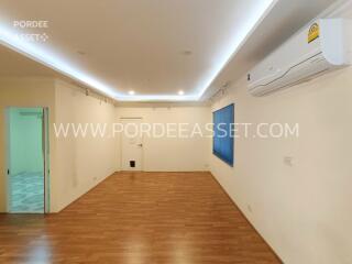 Spacious living room with wooden flooring, recessed lighting, and air conditioning