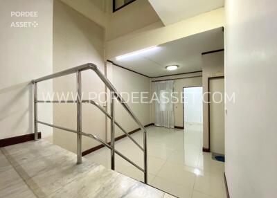 Indoor hallway with marble staircase and glossy ceramic tiled flooring