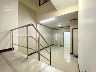 Indoor hallway with marble staircase and glossy ceramic tiled flooring