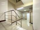 Indoor hallway with marble staircase and glossy ceramic tiled flooring