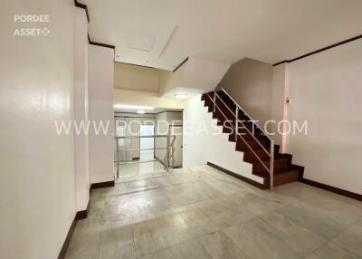 Main living area with staircase and marble flooring