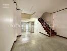 Main living area with staircase and marble flooring