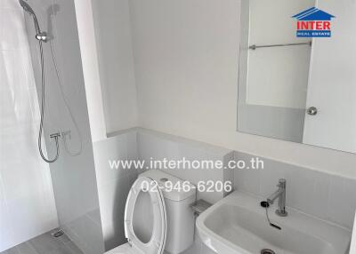 Bathroom with shower, toilet, sink, and mirror