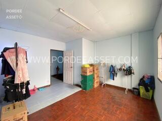 Bedroom with wooden flooring and open storage boxes