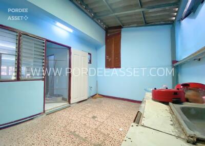 Spacious kitchen with tiled floor and metal roof