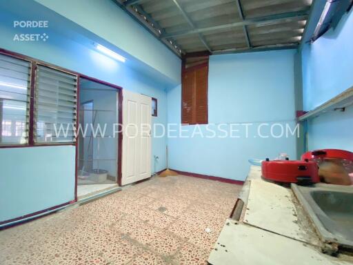 Spacious kitchen with tiled floor and metal roof