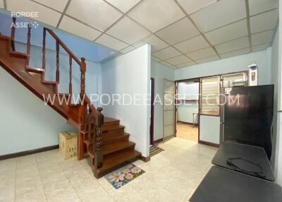 Living room with staircase and tiled floor