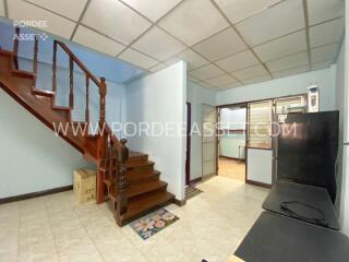 Living room with staircase and tiled floor