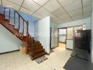 Living room with staircase and tiled floor