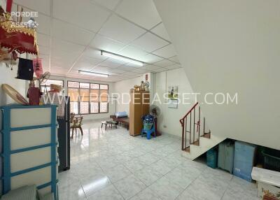 Spacious living room with tiled flooring and staircase