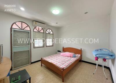 Bedroom with double bed, air conditioner, and window.