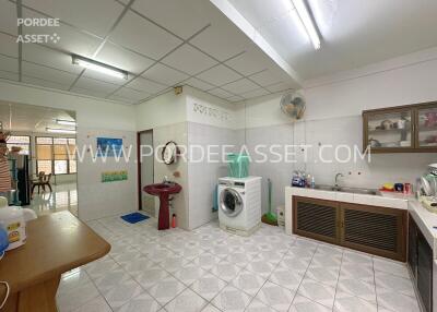 Spacious kitchen area with washing machine and sink