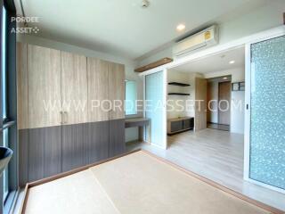 Modern bedroom with wooden wardrobe and large windows