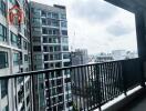 View from the balcony overlooking nearby buildings and distant cityscape