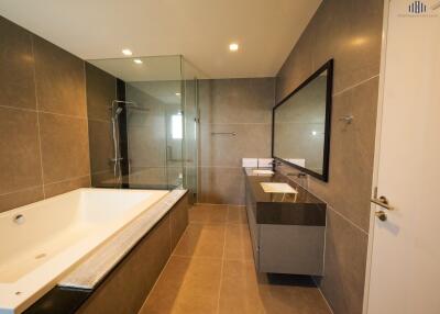 Modern bathroom with bathtub, shower, and double vanity