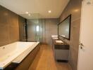 Modern bathroom with bathtub, shower, and double vanity