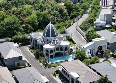 Aerial view of a large house with a domed structure