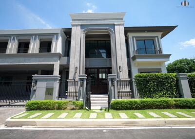 Modern multi-story house with green lawn