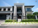 Modern multi-story house with green lawn