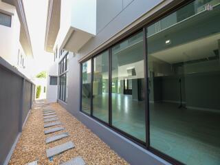 Modern building with large glass windows and gravel walkway