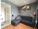 cozy living room with gray sofa and wall-mounted shelves