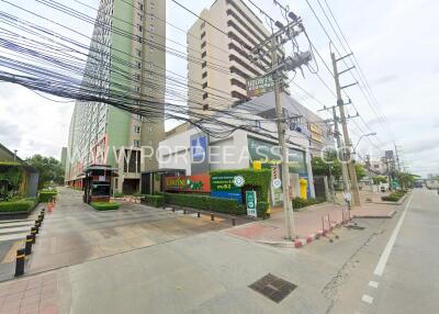 Exterior view of a multi-storey residential building with commercial establishments