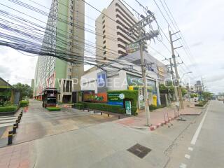 Exterior view of a multi-storey residential building with commercial establishments