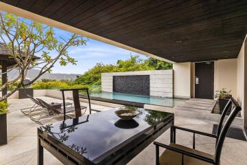 Modern outdoor patio with pool and scenic view