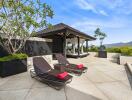 Outdoor patio with lounge chairs and gazebo