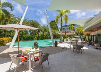 Outdoor pool area with seating and umbrellas