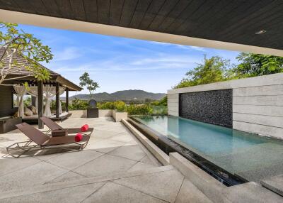 Luxurious outdoor area with pool and lounge chairs