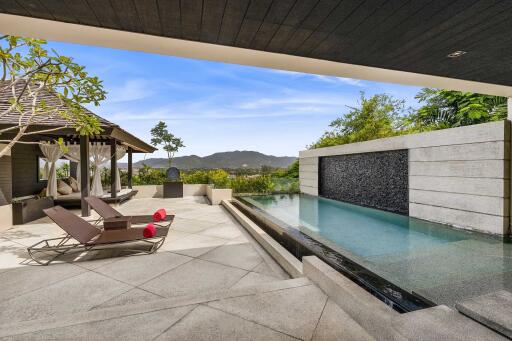 Luxurious outdoor area with pool and lounge chairs