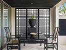 Modern outdoor patio area with black furniture and decorative elements