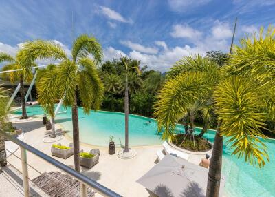 Outdoor swimming pool with palm trees and clear blue sky